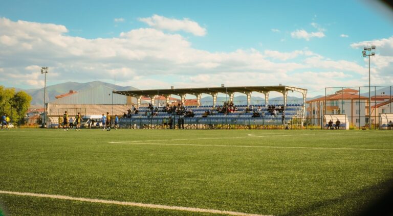 Non-league football match with spectators in a covered stand