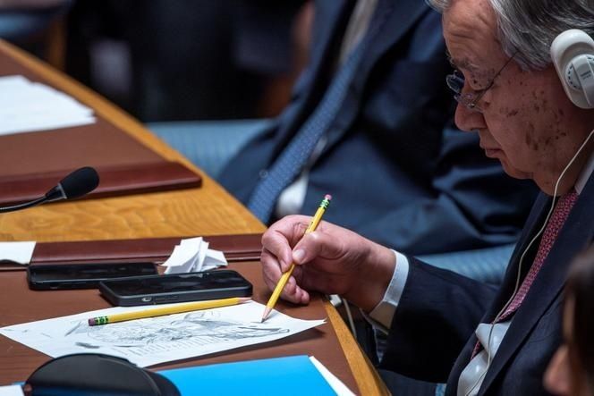 Official wearing headphones reviews papers and takes notes at a desk